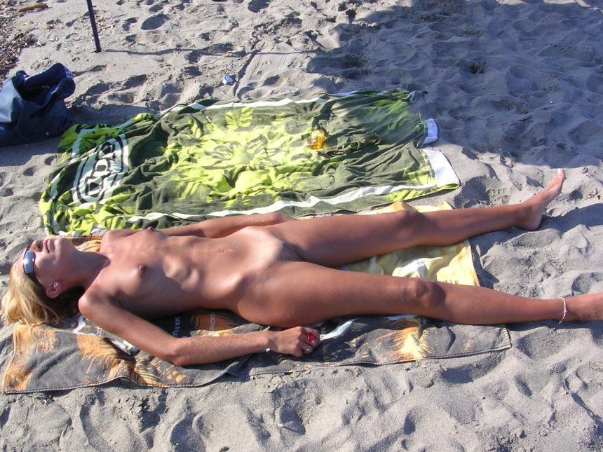 Fully naked milf on the beach.